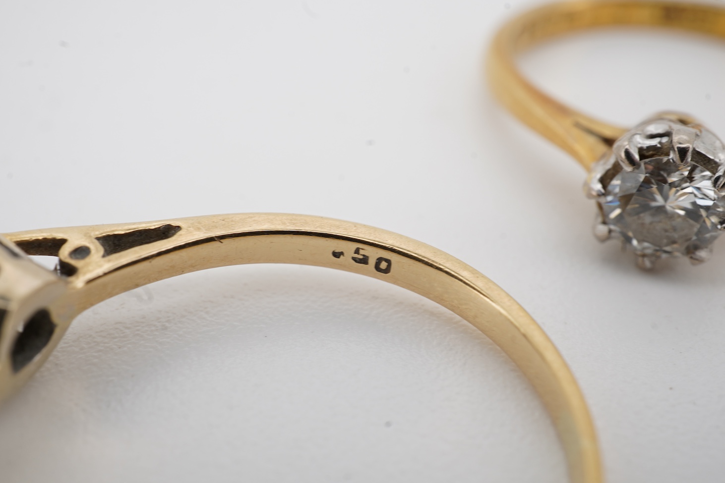 An early 1970's 18ct gold and claw set solitaire diamond ring, size K/L, the stone weighing approx. 0.33ct, together with a yellow metal and solitaire diamond ring, the stone weighing approx. 0.50ct, size P/Q, gross weig